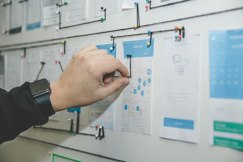 Project manager organizing tasks on a planning board